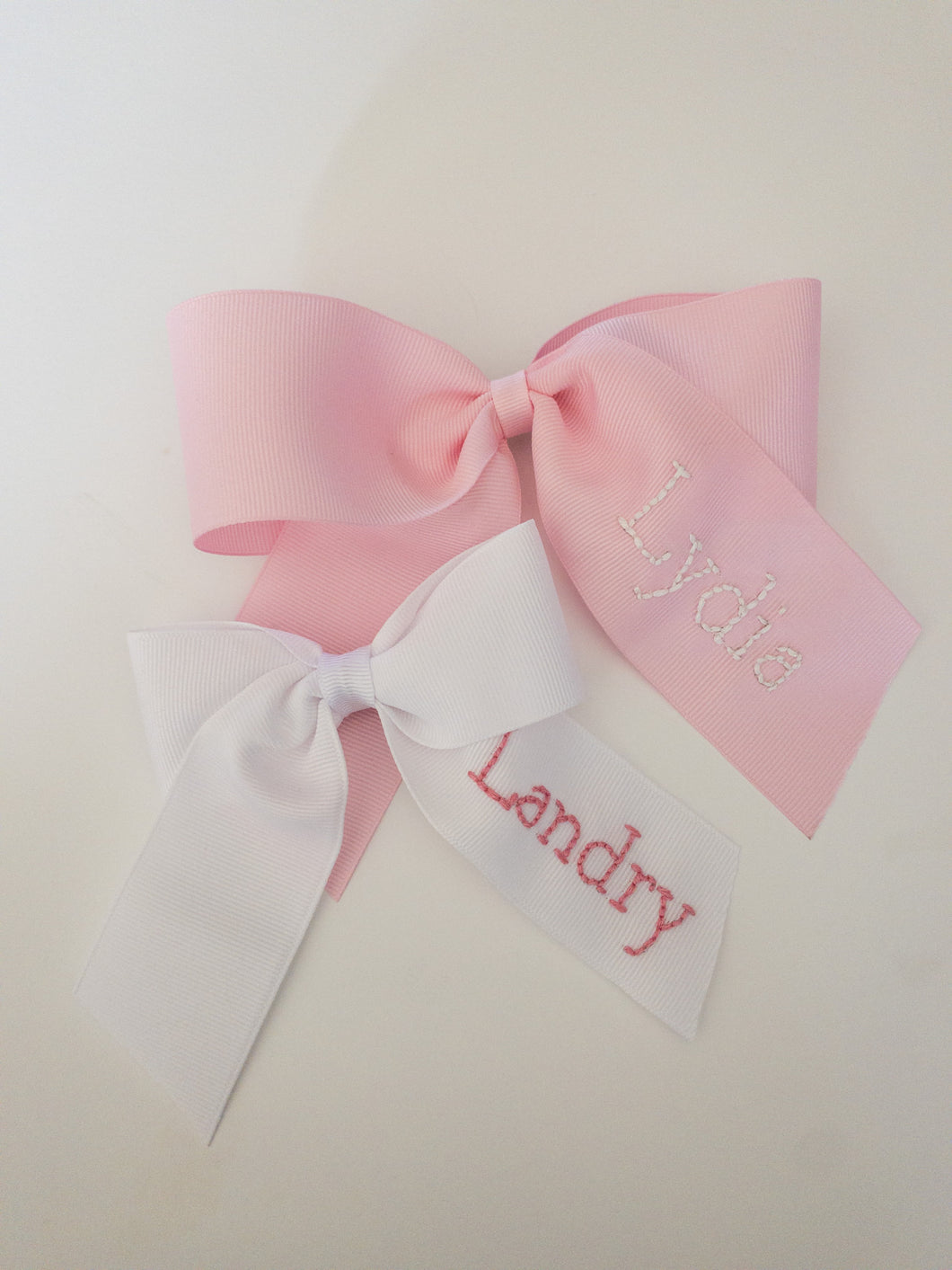 White Name on Light Pink Ribbon – A Girl and Two Bows